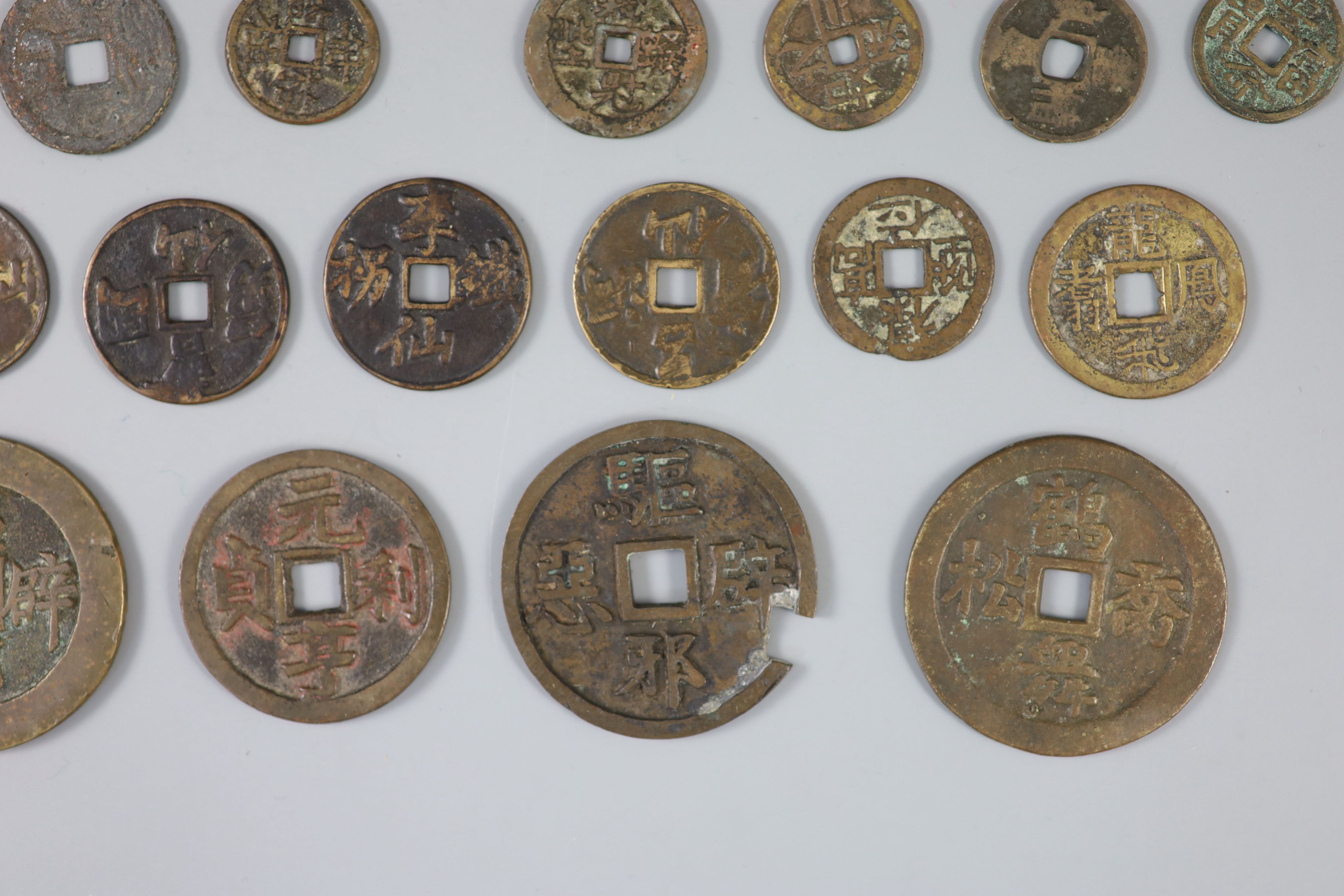 China, a group of 26 bronze or brass charms or amulets, Qing dynasty,